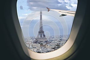 Aerial view Paris cityscape through airplane window while approaching to airport