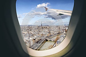 Aerial view Paris cityscape through airplane window while approaching to airport
