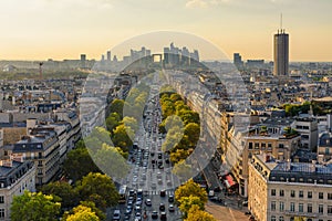 Aerial view of Paris with Eiffel Tower and Champs Elysees from the roof of the Triumphal Arch. Panoramic sunset view of photo