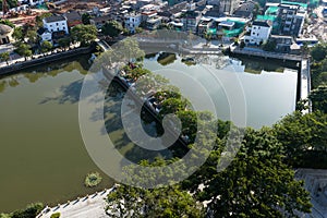 Aerial view of the park's lake and pedestrian bridge
