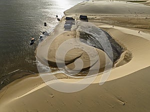 Aerial view of Parque da Dunas - Ilha das Canarias, Brazil. Huts and boats and sand dunes.