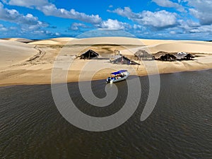 Aerial view of Parque da Dunas - Ilha das Canarias, Brazil. Huts and boats and sand dunes.