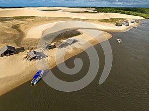 Aerial view of Parque da Dunas - Ilha das Canarias, Brazil. Huts and boats and sand dunes.