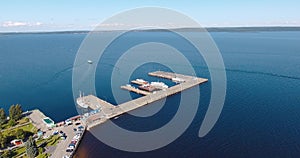 Aerial view of passenger hydrofoil ship departs from city pier