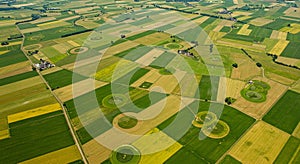 Aerial view of patchwork farmland featuring various rectangular fields in shades of photo