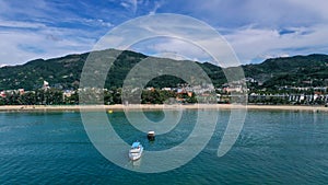 Aerial view of Patong beach in Phuket Province, Thailand with boat parking on the sea. Taken by drone from above of the