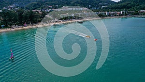 Aerial view of Patong beach with tourist enjoying the beach and watersport activity.
