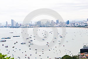 Aerial view Pattaya City and Beach Sea in Twilight, Thailand. There are many boats in bay to serve tourists