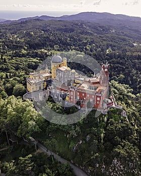 Aerial view of Pena Palace, a hilltop Romanticist palace in parkland at sunset, Sintra, Lisbon, Portugal