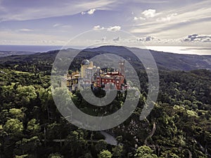 Aerial view of Pena Palace, a hilltop Romanticist palace in parkland at sunset, Sintra, Lisbon, Portugal
