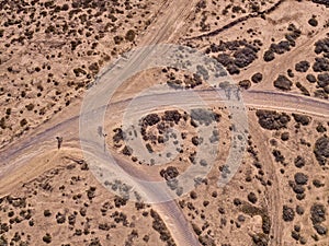 Aerial view of people cycling on a dirt path in the island of La Graciosa, Lanzarote, Canary Islands. Spain.