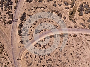 Aerial view of people cycling on a dirt path in the island of La Graciosa, Lanzarote, Canary Islands. Spain.