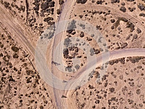 Aerial view of people cycling on a dirt path in the island of La Graciosa, Lanzarote, Canary Islands. Spain.