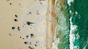 Aerial view of people enjoying and lifeguard house at the beach in Los Angeles, California