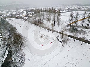 Aerial view of people playing on sledges during a snowstorm (Ebbw Vale, Wales