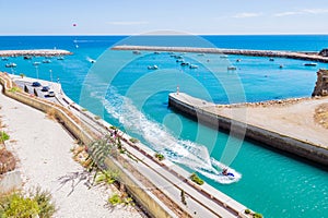 Aerial view of people riding a jet powered boat in Porto de Abrigo de Albufeira, Albufeira Bay in Albufeira, Portugal photo