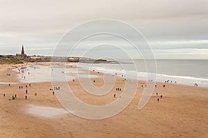 Aerial view of people strolling on beach in North Shields photo