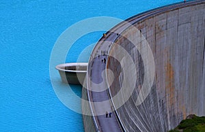 Aerial view of people walking down the scenic trail of the Stausee Kops reservoir in Austria.