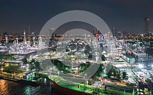 Aerial view of petrochemical oil refinery and sea in industrial engineering concept in Bangna district at night, Bangkok City,
