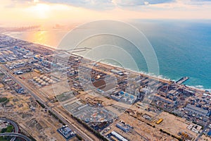 Aerial view of petrochemical oil refinery and sea in industrial engineering and energy concept in Dubai, urban city, UAE. Oil and