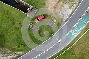Aerial view photo high angle view top down of red suv car and asphalt curve road