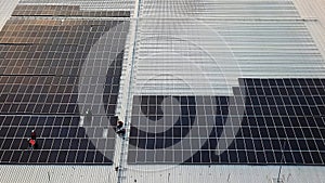 Aerial view of photovoltaic solar panels installation work activity at rooftop