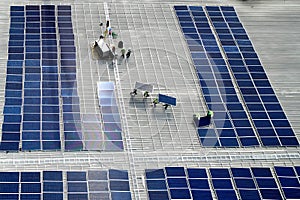 Aerial view of photovoltaic solar panels installation work activity at rooftop