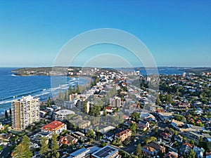 Aerial view of a picturesque residential neighborhood nestled alongside a serene body of water