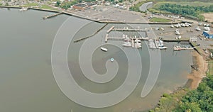 An aerial view of a pier harbor port with many boats