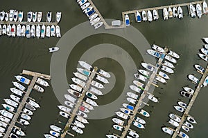 An aerial view of a pier harbor port with many boats