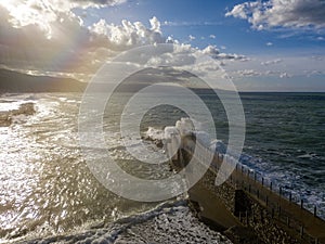 Aerial view of a pier with rocks. Pizzo Calabro pier, panoramic view from above. Broken pier, force of the sea. Power of Waves. N