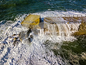 Aerial view of a pier with rocks. Pizzo Calabro pier, panoramic view from above. Broken pier, force of the sea. Power of Waves. N