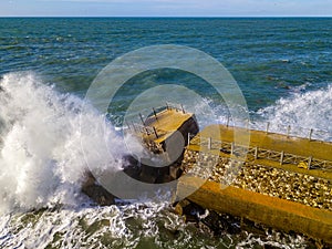 Aerial view of a pier with rocks. Pizzo Calabro pier, panoramic view from above. Broken pier, force of the sea. Power of Waves. N