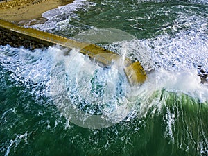 Aerial view of a pier with rocks. Pizzo Calabro pier, panoramic view from above. Broken pier, force of the sea. Power of Waves. N