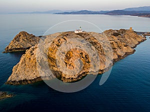 Aerial view of the Pietra Lighthouse and the Genoese tower at sunset. Red Island, Corsica, France