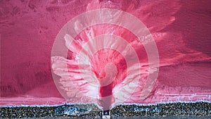 Aerial view of pink salt lake. Salt production plants evaporated brine pond in a salt lake.