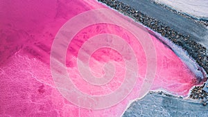 Aerial view of pink salt lake. Salt production plants evaporated brine pond in a salt lake.