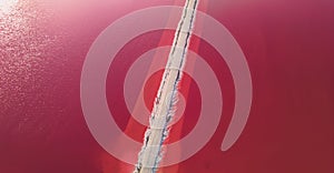 Aerial view of pink salt lake. Salt production plants evaporated brine pond in a salt lake.