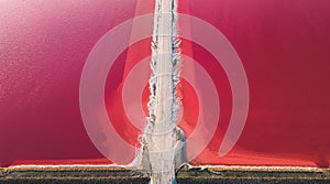 Aerial view of pink salt lake. Salt production plants evaporated brine pond in a salt lake.