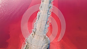 Aerial view of pink salt lake. Salt production plants evaporated brine pond in a salt lake.