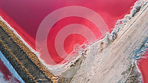 Aerial view of pink salt lake. Salt production plants evaporated brine pond in a salt lake.