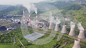 Aerial view of the pipes of a coal power plant and cooling tower