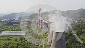 Aerial view of the pipes of a coal power plant and cooling tower