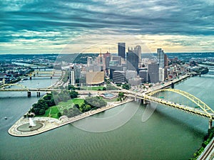 Aerial view of  Pittsburgh downtown skyline over the bridge on under dramatic sky