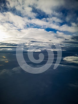 Aerial view from plane to morning sunrise over clouds