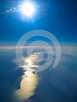Aerial view from plane to morning sunrise over the ocean