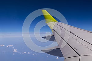 Aerial view from plane window with airplane wing