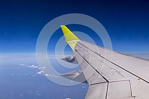 Aerial view from plane window with airplane wing