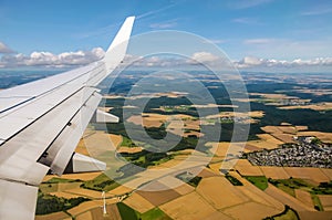 Aerial view of plane wing and fields