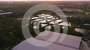 Aerial view of the pool of wastewater treatment facilities during sunset 4K slow motion